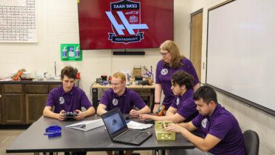 Robot group discussing strategy over table